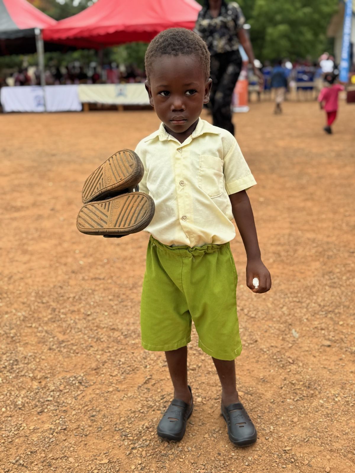 Child holding shoes
